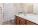 Clean bathroom with a single sink, wooden cabinetry, and a shower with a curtain at 20941 E Pecan Ln, Queen Creek, AZ 85142