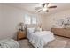Cozy bedroom with neutral decor, a ceiling fan, and a comfortable bed with stylish bedding at 20941 E Pecan Ln, Queen Creek, AZ 85142