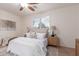Cozy bedroom with plush bedding, neutral decor, and a large window with shutters at 20941 E Pecan Ln, Queen Creek, AZ 85142