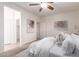 Bedroom with carpet flooring, ceiling fan, and white doors leading to other rooms at 20941 E Pecan Ln, Queen Creek, AZ 85142