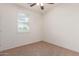 Neutral bedroom with carpet, a window with blinds, and a ceiling fan at 20941 E Pecan Ln, Queen Creek, AZ 85142