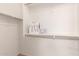 Walk-in closet space with clothing rods and organized shopping bags at 20941 E Pecan Ln, Queen Creek, AZ 85142