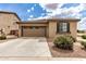 A beautiful home with a large driveway and a two-car garage with unique windows at 20941 E Pecan Ln, Queen Creek, AZ 85142