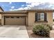 Charming single-story home featuring a tile roof, two-car garage, and neat desert landscaping at 20941 E Pecan Ln, Queen Creek, AZ 85142