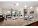 Stylish kitchen with a center island, stainless steel sink, granite countertops and an adjacent dining and living area at 20941 E Pecan Ln, Queen Creek, AZ 85142