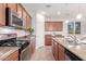 Modern kitchen with stainless steel appliances, granite countertops, and ample cabinet space at 20941 E Pecan Ln, Queen Creek, AZ 85142