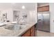 Stylish kitchen featuring granite counters, stainless steel appliances, and a deep stainless sink at 20941 E Pecan Ln, Queen Creek, AZ 85142