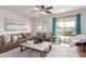 Comfortable living room with tile floor, lots of natural light, and a sliding door to the backyard at 20941 E Pecan Ln, Queen Creek, AZ 85142