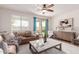 Comfortable living room with tile floor, lots of natural light, and a sliding door to the backyard at 20941 E Pecan Ln, Queen Creek, AZ 85142
