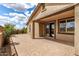 Charming covered patio with brick pavers and sliding glass doors, perfect for outdoor entertaining at 20941 E Pecan Ln, Queen Creek, AZ 85142