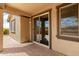 Covered patio with brick pavers, sliding glass doors, and a serene view at 20941 E Pecan Ln, Queen Creek, AZ 85142