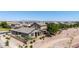 Backyard aerial of a home featuring a desert landscaped yard, patio, and beautiful desert walking trail at 20941 E Pecan Ln, Queen Creek, AZ 85142