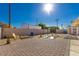 Expansive backyard featuring a brick-paved patio, pergola, and a cozy fire pit area for outdoor enjoyment at 2131 W Verde Ln, Phoenix, AZ 85015
