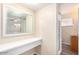 Bright bathroom featuring a vanity area, large mirror, and a shower at 2131 W Verde Ln, Phoenix, AZ 85015
