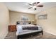 Inviting bedroom with a ceiling fan, wood-look floors, and natural light at 2131 W Verde Ln, Phoenix, AZ 85015