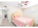 Bedroom with ceiling fan, wood-look floors, and antique-look bed frame at 2131 W Verde Ln, Phoenix, AZ 85015