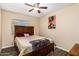 Bedroom with ceiling fan, wood-look floors, and wooden slat headboard at 2131 W Verde Ln, Phoenix, AZ 85015