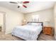 Serene bedroom with a ceiling fan, wood-look floors, and comfortable furnishings at 2131 W Verde Ln, Phoenix, AZ 85015