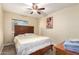 Comfortable bedroom with ceiling fan, wood-look floors, and wooden slat headboard at 2131 W Verde Ln, Phoenix, AZ 85015