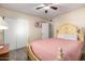 Bedroom with closet, ceiling fan, wood-look floors, and antique-look bed frame at 2131 W Verde Ln, Phoenix, AZ 85015
