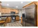 Well-lit kitchen featuring stainless steel appliances, granite countertops, and updated wood cabinetry at 2131 W Verde Ln, Phoenix, AZ 85015