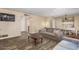 Inviting living room with wood-look floors and a dining table set for a cozy meal at 2131 W Verde Ln, Phoenix, AZ 85015