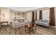 Inviting living room featuring neutral paint, wood-look tile floors, and comfortable seating at 2131 W Verde Ln, Phoenix, AZ 85015