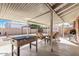View of the covered patio with foosball table and seating area at 2131 W Verde Ln, Phoenix, AZ 85015