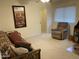 Bedroom with a futon, recliner, carpeted floors, and a well-lit window at 2152 S Olivewood --, Mesa, AZ 85209