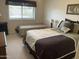Cozy bedroom features two beds, neutral walls, and plenty of natural light at 2152 S Olivewood --, Mesa, AZ 85209