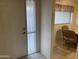 Bright foyer with tiled flooring leading to a cozy dining area, offering a warm welcome into this charming home at 2152 S Olivewood --, Mesa, AZ 85209