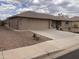 Charming single-story home with a desert landscape, stone accents, and a spacious driveway leading to a two-car garage at 2152 S Olivewood --, Mesa, AZ 85209