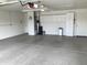 Spacious garage features white brick walls, concrete flooring and storage cabinets at 2152 S Olivewood --, Mesa, AZ 85209
