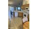 Bright kitchen featuring oak cabinets, white appliances, and a breakfast nook, seamlessly connecting to the dining area at 2152 S Olivewood --, Mesa, AZ 85209