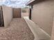 Side yard with secure gate access, providing privacy and convenience with desert landscaping at 2152 S Olivewood --, Mesa, AZ 85209