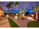 Stunning outdoor living area with a dining set, seating area, and firepit with meticulously landscaped surroundings at 22912 N San Ramon Ct, Sun City West, AZ 85375