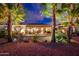 Beautifully landscaped backyard featuring a stone fire pit, mature palm trees, and a tranquil outdoor setting at 22912 N San Ramon Ct, Sun City West, AZ 85375