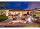 Beautiful backyard features a fire pit and a covered seating area perfect for entertaining guests at 22912 N San Ramon Ct, Sun City West, AZ 85375
