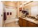 Well-lit bathroom with a tub and shower combination, granite countertops, and neutral-toned walls at 22912 N San Ramon Ct, Sun City West, AZ 85375