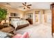A lovely bedroom with ensuite bath access, decorated with neutral tones and carpet at 22912 N San Ramon Ct, Sun City West, AZ 85375