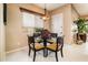 Casual breakfast nook bathed in natural light, complemented by a stylish chandelier at 22912 N San Ramon Ct, Sun City West, AZ 85375