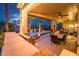 Inviting covered patio with an outdoor kitchen and dining area with views of the backyard at 22912 N San Ramon Ct, Sun City West, AZ 85375