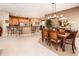 Open-concept dining area adjacent to kitchen with breakfast bar and modern appliances at 22912 N San Ramon Ct, Sun City West, AZ 85375