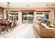 Bright dining area featuring outdoor access and views, adjacent to a living area at 22912 N San Ramon Ct, Sun City West, AZ 85375