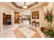 Spacious foyer with tile flooring, elegant decor, and seamless transition to living spaces at 22912 N San Ramon Ct, Sun City West, AZ 85375