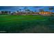 Picturesque golf course featuring a green with flag, sand trap, and beautiful houses in the background at 22912 N San Ramon Ct, Sun City West, AZ 85375