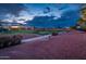 Scenic view of golf course showcasing a path with the fairway and residential houses at 22912 N San Ramon Ct, Sun City West, AZ 85375