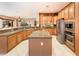 Open kitchen layout featuring granite countertops, island, and modern stainless appliances at 22912 N San Ramon Ct, Sun City West, AZ 85375