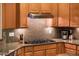 A kitchen area featuring granite countertops, wood cabinets, and stainless steel appliances like a range at 22912 N San Ramon Ct, Sun City West, AZ 85375