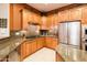 Modern kitchen showcasing granite countertops, stainless appliances, and wood cabinets at 22912 N San Ramon Ct, Sun City West, AZ 85375